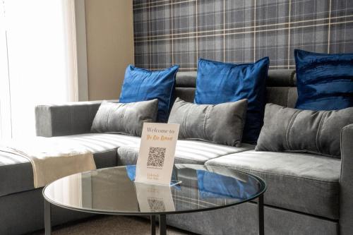 a living room with a couch and a table with blue pillows at The Rise Retreat in Livingston
