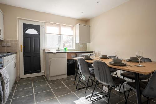 a kitchen with a table and chairs and a kitchen with a counter at The Rise Retreat in Livingston