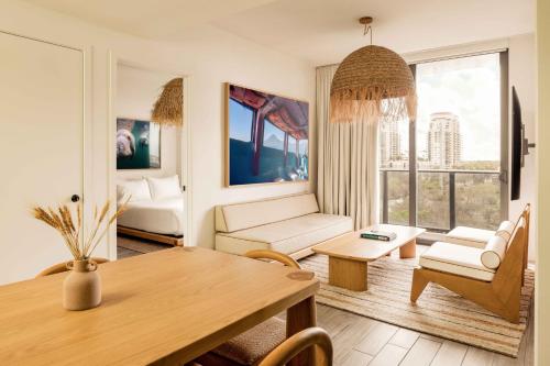 a living room with a table and chairs and a couch at Flow Fort Lauderdale Hotel in Fort Lauderdale