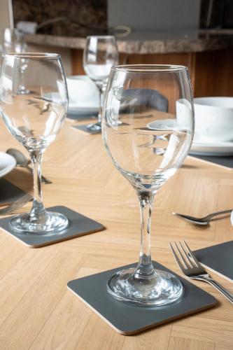 two empty wine glasses sitting on a table at Marina House in Bathgate