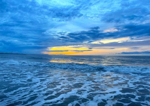 a view of the ocean with a cloudy sky at 3BR Home Near Beach, Pool, Local Vibes in Manzanillo