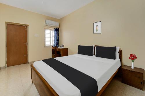 Postel nebo postele na pokoji v ubytování Super Hotel O Chinnamuthu Main Street