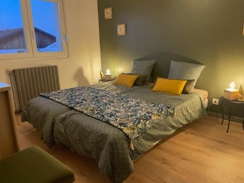a bedroom with a large bed with yellow pillows at Gite Nicole in Jeuxey