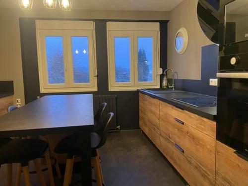 a kitchen with a table and a counter top at Gite Nicole in Jeuxey