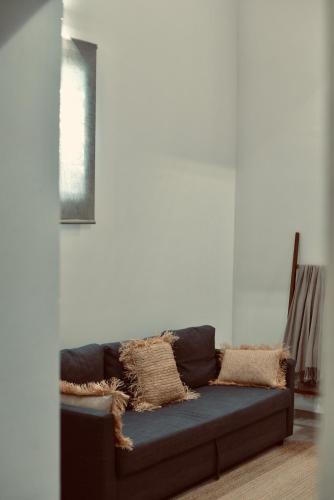a couch sitting in a living room at Palermo Inn Boutique Hotel in Palermo
