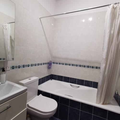 a bathroom with a tub and a toilet and a sink at Andromeda Hideaway in Polis Chrysochous