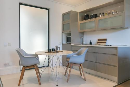 a kitchen with a table and two chairs at 110 The Gallery luxury apartment in Knysna