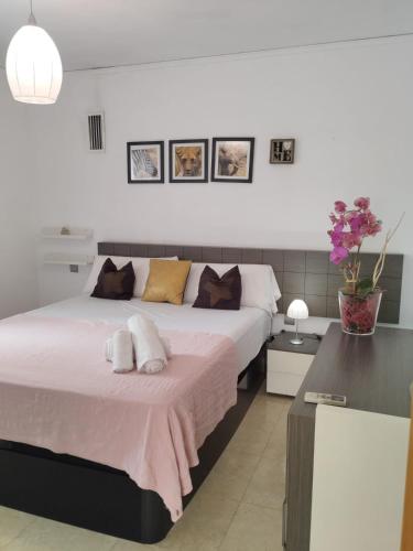a bedroom with a large bed with two pillows on it at Los Iris Solo Familias Serviplaya in Playa de Gandia