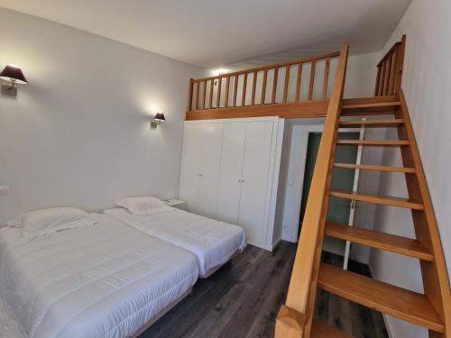 a bedroom with a bunk bed and a ladder at Casa da Portelinha in Paredes de Coura