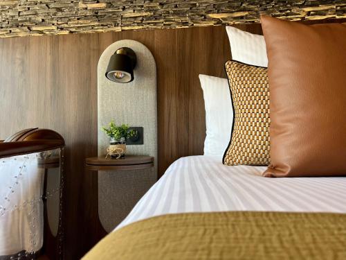 a bedroom with a bed with a pillow and a lamp at Cocoon inn in Cucq
