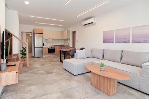 a living room with a couch and a table at Agios Nikolaos Villas in Ayios Nikolaos Sithonia