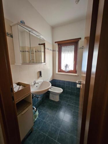 a bathroom with a sink and a toilet and a window at Residenza Montessori in Avezzano
