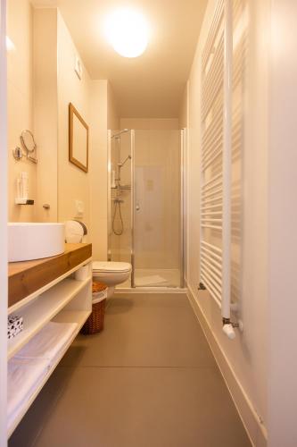 a white bathroom with a sink and a shower at Vadkert Major in Sárvár