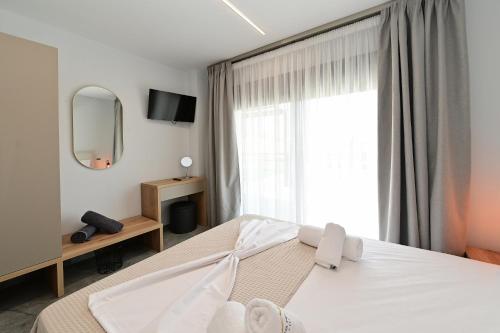 a bedroom with a bed and a large window at Agios Nikolaos Villas in Ayios Nikolaos Sithonia