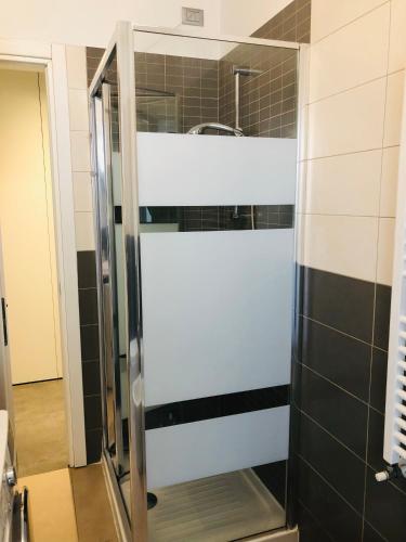 a glass shower door in a bathroom with a sink at SKY Apartment Pero in Pero