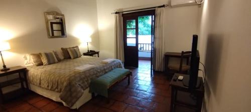 a bedroom with a bed and a television in it at Las Moras Hotel in San Lorenzo