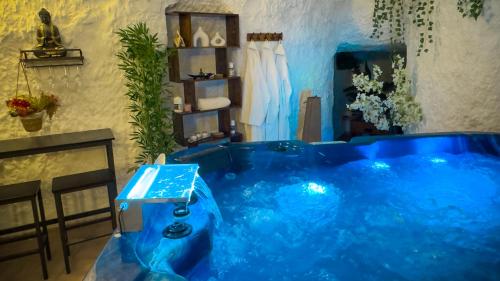 a large blue tub in a bathroom with a sink at Casa Spa Alcalá del Júcar in Alcalá del Júcar