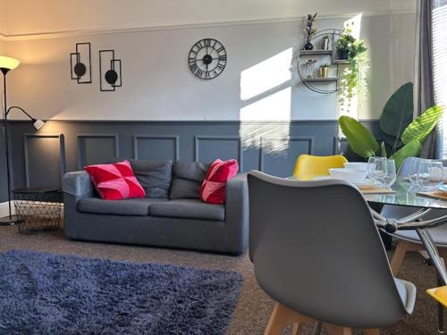 a living room with a couch and a table at Chanterlands House in Hull
