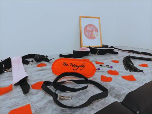 an orange bag sitting on top of a bed at Lovers' Nest - Spa Apartment in Rome