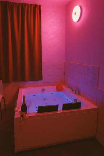a room with a tub with a person sitting in it at Lovers' Nest - Spa Apartment in Rome