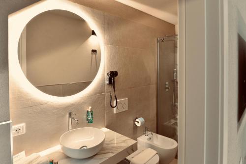 a bathroom with a sink toilet and a mirror at Palermo Inn Boutique Hotel in Palermo