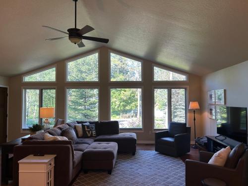 a living room with a couch and chairs and windows at Whitefish Home, 3 BED 2 BATH, Sleeps 7, Hot Tub, AC in Whitefish
