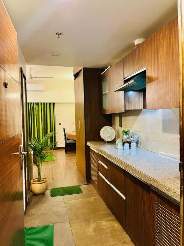 a kitchen with wooden cabinets and a counter top at SkyNest in Dehradun