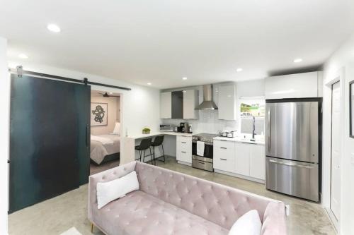 a living room and kitchen with a couch in a room at 1BD 1BA-Black&White ArtBNB Cottage-Antique Row WPB in West Palm Beach