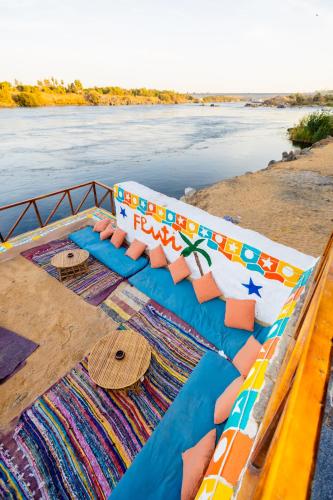 a boat on a river with a view of the water at Fenti Nubian Resort in Aswan