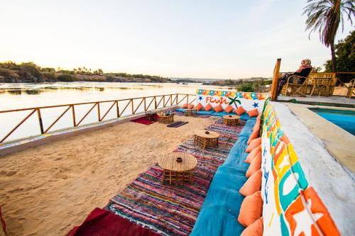 a person sitting in a chair on the beach at Fenti Nubian Resort in Aswan