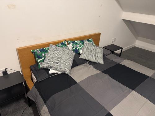 a bedroom with a bed with pillows on it at Sowerby Apartment in Sowerby Bridge