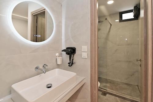 a bathroom with a sink and a shower at Agios Nikolaos Villas in Ayios Nikolaos Sithonia