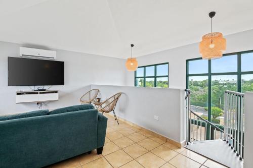 a living room with a couch and a tv at The Best PentHouse In Aquatika Pool Front in Vieques