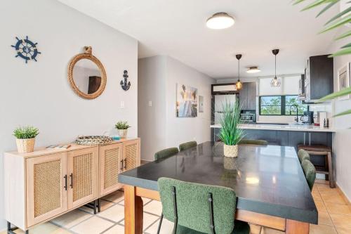 a kitchen and dining room with a table and chairs at The Best PentHouse In Aquatika Pool Front in Vieques