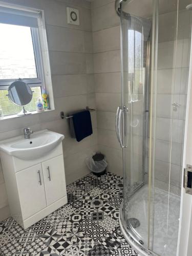 a bathroom with a shower and a sink at Grange House in Omagh