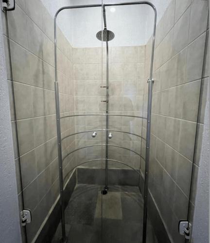 a shower with a glass door in a bathroom at HOTEL PERDIZES - FLAT Executivo - 1403 in Sao Paulo