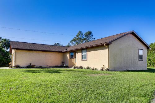 a large house with a large grass yard at Port Charlotte Home Near Beaches and Dining in Port Charlotte