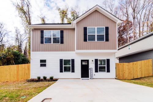 a house with a white at Chic Home 9 min to Uptown Hot Tub & Private Yard in Charlotte
