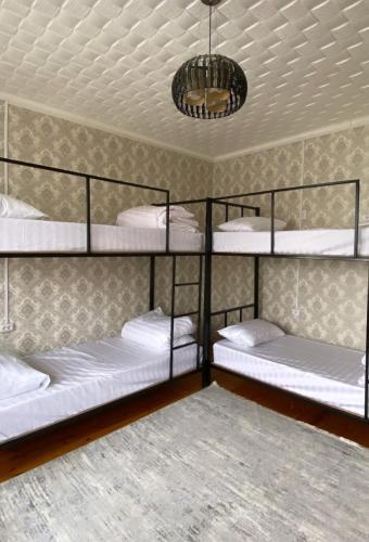a room with four bunk beds in it at My Hostel in Osh