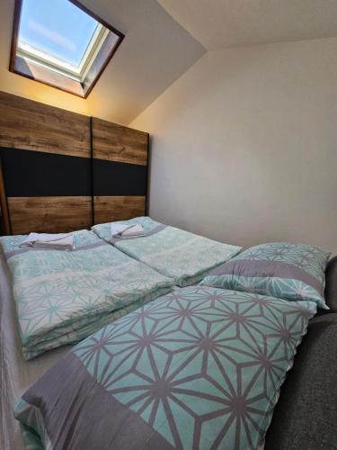 a bedroom with a large bed with a window at Apartman SEA VIEW in Vantačići