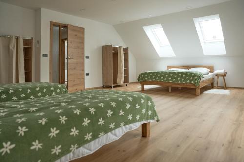 a bedroom with two beds with green and white sheets at Vila Vinita in Sveti Jurij ob Ščavnici