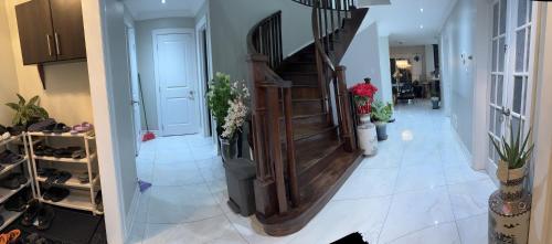 a hallway with a staircase in a house at Private Single Bedroom in City Centre Q66 in Mississauga