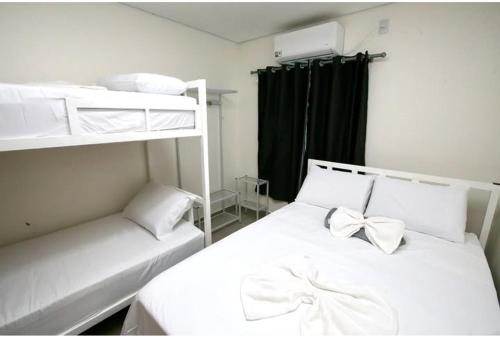 Ένα ή περισσότερα κρεβάτια σε δωμάτιο στο Hotel Paraiso Go