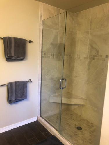 a shower with a glass door in a bathroom at Whitefish Home, Sleeps 7, Hot Tub, AC in Whitefish