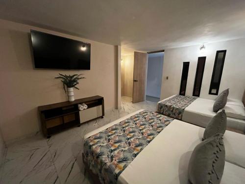 Cama o camas de una habitación en HOTEL BALI AT POBLADO