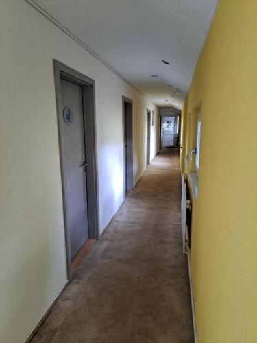 an empty hallway of an office building with doors at W.I.P. Welt im Park in Dresden
