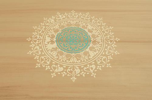 a drawing of a mandala on a wooden surface at Il Carrubo in Alghero