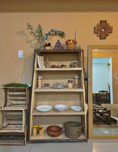 a shelf with plates on it in a room at Cosy apartment in the heart of Pisac with rooftop in Pisac