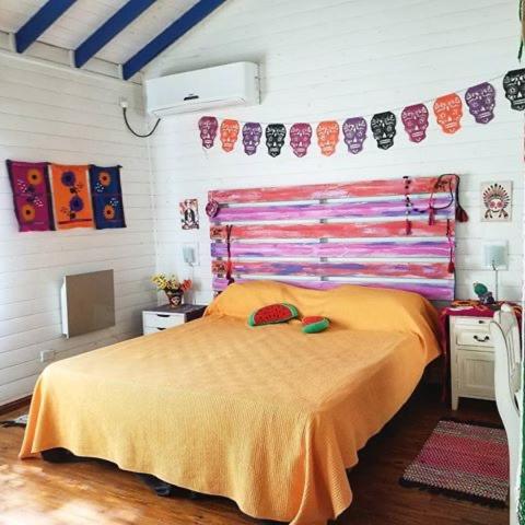 a bedroom with a bed with two hats on it at Itaca delta cabañas in Tigre