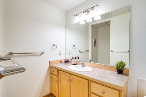 a bathroom with a sink and a large mirror at Klamath Falls Getaway with Pool and Hot Tub Access! in Klamath Falls